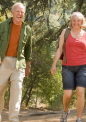 A couple go on a hike through a park. Their joints are not experiencing much stress.